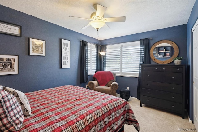 bedroom featuring ceiling fan, light colored carpet, and a textured wall