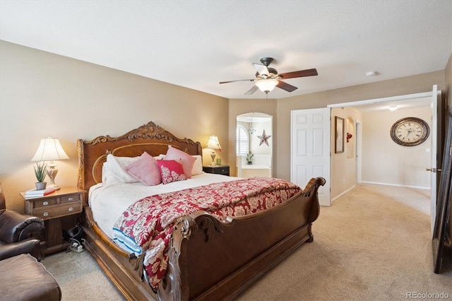 bedroom featuring baseboards, light carpet, and ceiling fan
