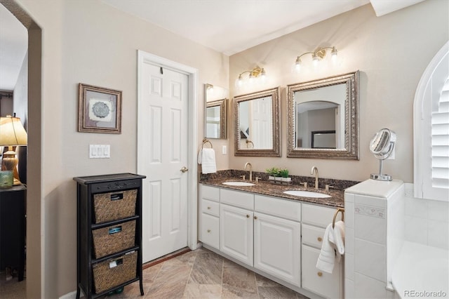 bathroom featuring double vanity and a sink