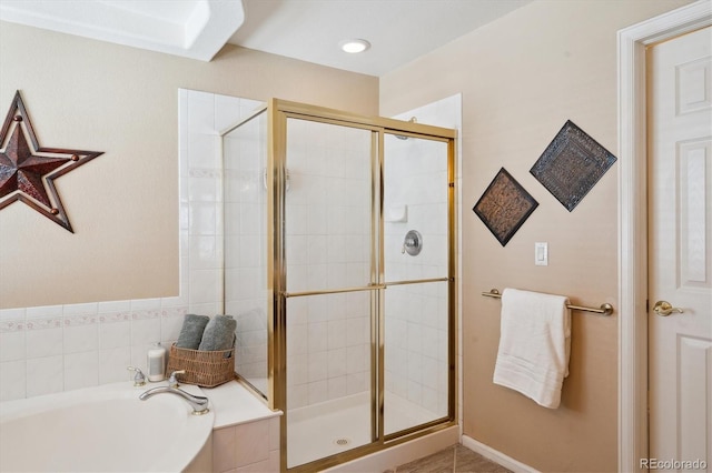 full bath featuring a garden tub and a stall shower