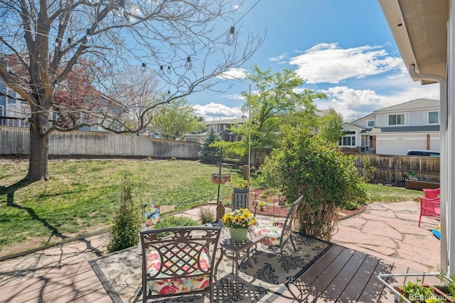exterior space featuring a fenced backyard, outdoor dining space, and a yard