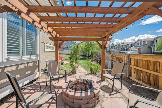 view of patio featuring a fenced backyard, a pergola, and a fire pit
