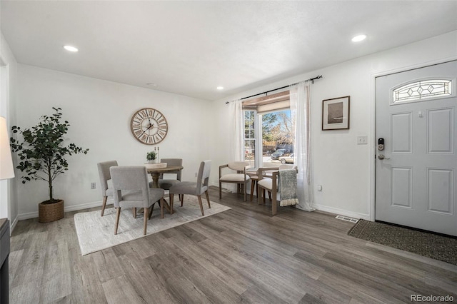 dining area with recessed lighting, wood finished floors, and baseboards