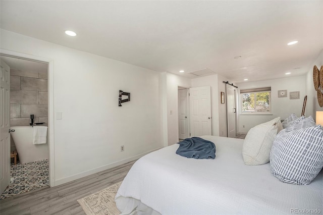 bedroom featuring light wood finished floors, recessed lighting, attic access, and baseboards