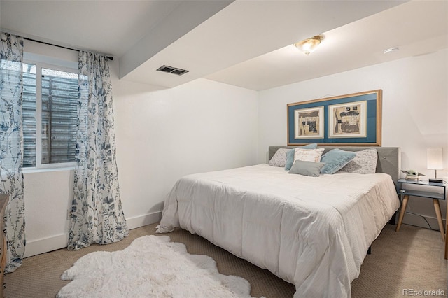 carpeted bedroom with visible vents and baseboards