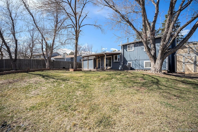 view of yard with a fenced backyard, a storage shed, and an outdoor structure