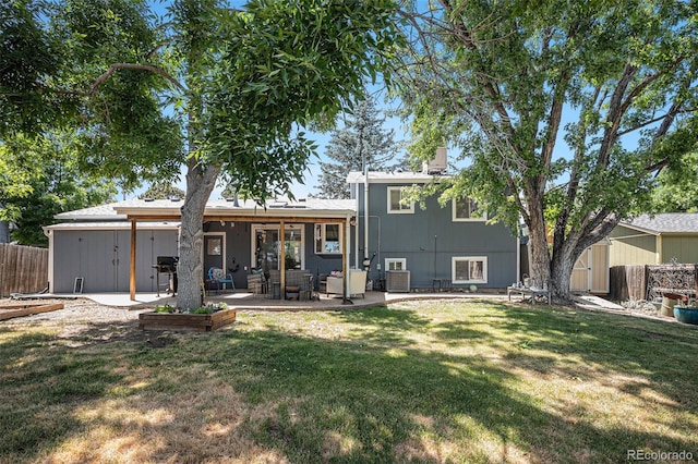 back of house featuring cooling unit, a patio, a yard, and fence