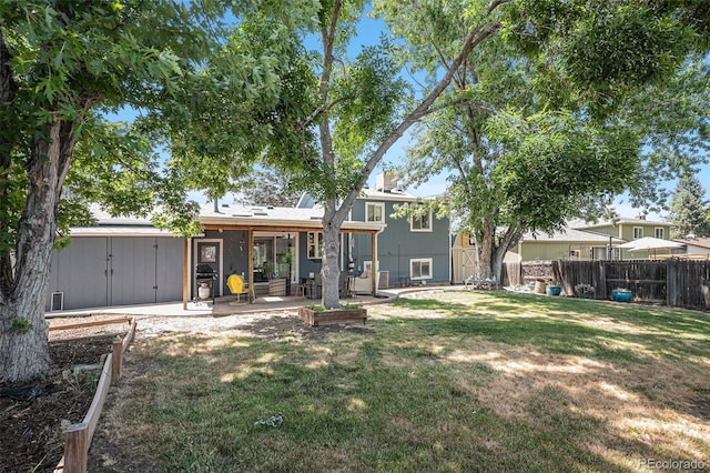 back of house with a patio area, a yard, and fence