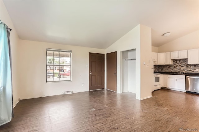 9061 Osceola St, Westminster, CO 80031 - unfurnished living room with lofted ceiling, dark wood-type flooring, baseboards, and a sink