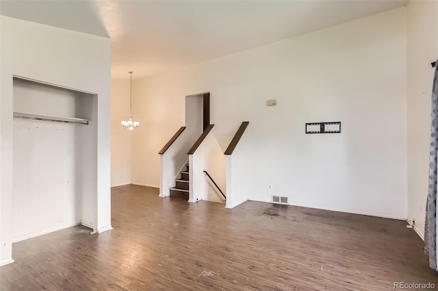 9061 Osceola St, Westminster, CO 80031 - unfurnished living room featuring a chandelier, wood finished floors, stairway, and baseboards