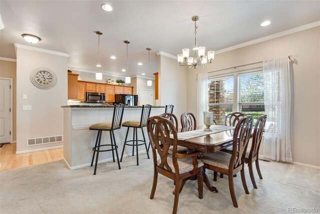 15501 E 112th Ave Unit 33D, Commerce City, CO 80022 - dining space featuring crown molding, a notable chandelier, visible vents, and light carpet