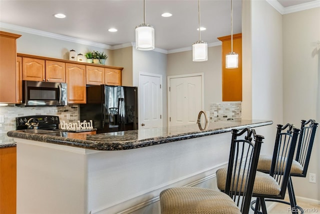 kitchen featuring dark stone counters, a peninsula, backsplash, and black appliances