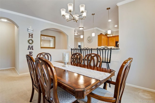 dining room with baseboards, a chandelier, and light carpet
