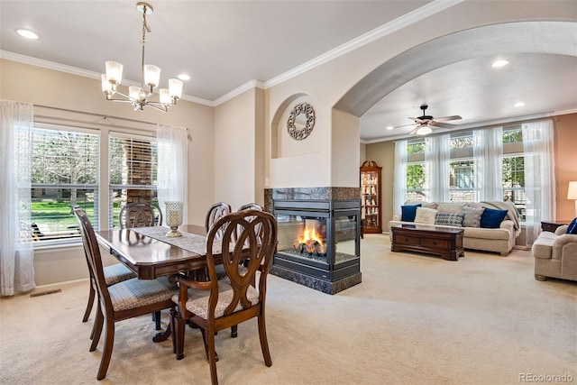 dining space featuring crown molding, recessed lighting, and light carpet