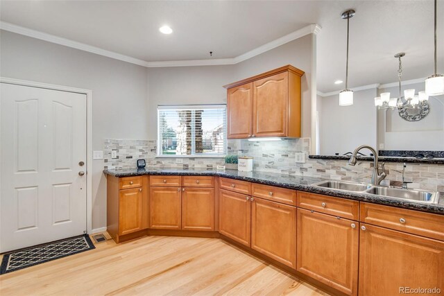15501 E 112th Ave Unit 33D, Commerce City, CO 80022 - kitchen with a sink, tasteful backsplash, light wood-style floors, and dark stone countertops