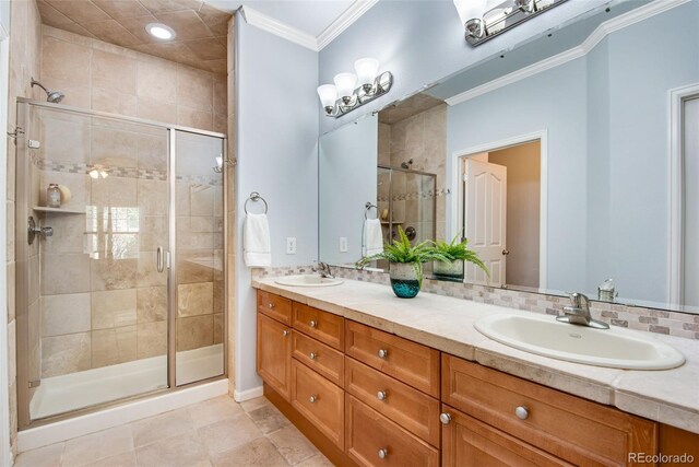 15501 E 112th Ave Unit 33D, Commerce City, CO 80022 - full bathroom with a shower stall, double vanity, ornamental molding, and a sink