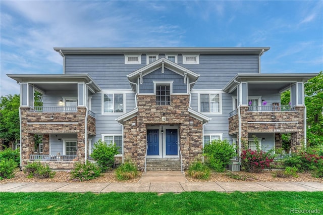 5255 Memphis St Unit 1009, Denver, CO 80239 - view of front of house with stone siding and a balcony