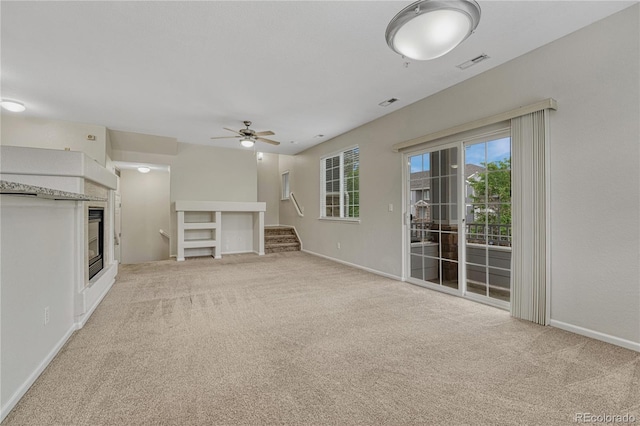 5255 Memphis St Unit 1009, Denver, CO 80239 - unfurnished living room with light carpet, ceiling fan, and stairway