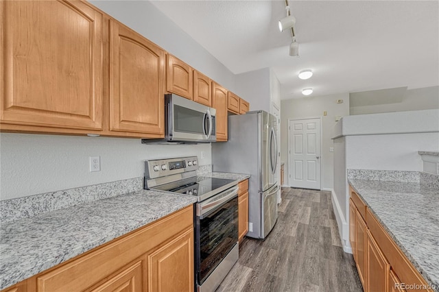 5255 Memphis St Unit 1009, Denver, CO 80239 - kitchen with stainless steel appliances, wood finished floors, light stone countertops, and track lighting