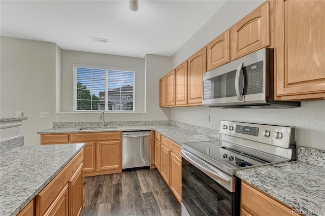 5255 Memphis St Unit 1009, Denver, CO 80239 - kitchen featuring stainless steel appliances, dark wood finished floors, and light stone countertops