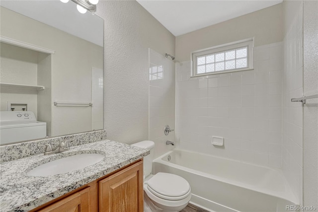 5255 Memphis St Unit 1009, Denver, CO 80239 - full bathroom featuring vanity, shower / bathtub combination, washer / clothes dryer, and a textured wall