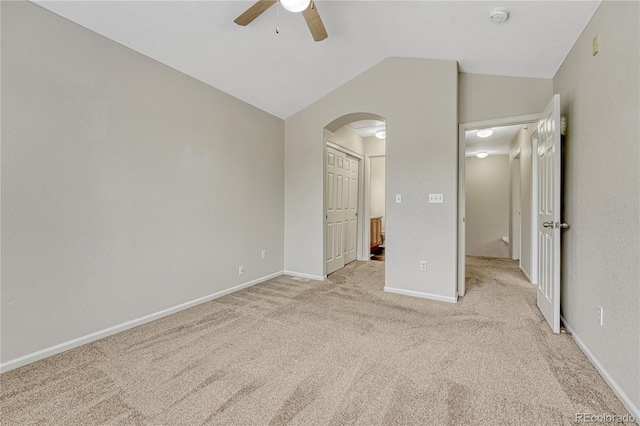 5255 Memphis St Unit 1009, Denver, CO 80239 - unfurnished bedroom featuring arched walkways, light colored carpet, vaulted ceiling, and ceiling fan