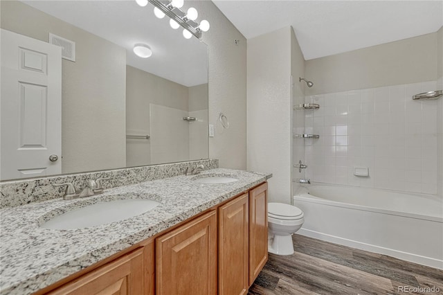 5255 Memphis St Unit 1009, Denver, CO 80239 - full bathroom with wood finished floors, double vanity, and washtub / shower combination
