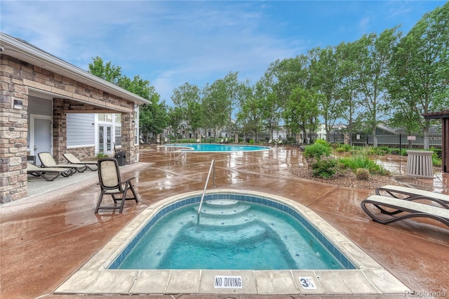 5255 Memphis St Unit 1009, Denver, CO 80239 - community pool with a hot tub, a patio, and french doors