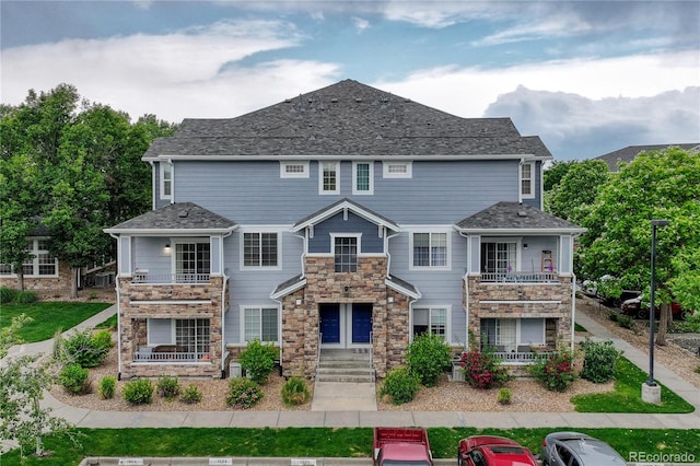 5255 Memphis St Unit 1009, Denver, CO 80239 - view of front of property with stone siding and a balcony