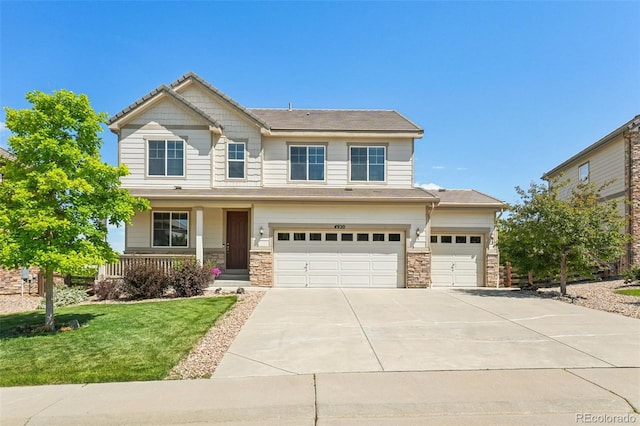 4920 S Netherland Way, Centennial, CO 80015 - craftsman inspired home featuring covered porch, concrete driveway, a garage, a front yard, and stone siding