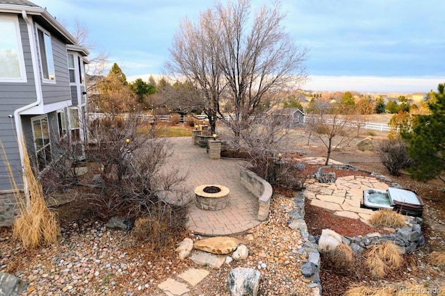 view of yard featuring a fire pit and a patio