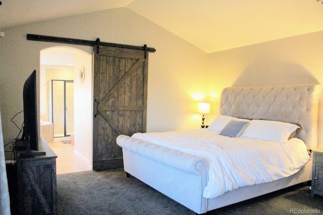 carpeted bedroom featuring a barn door, arched walkways, and vaulted ceiling