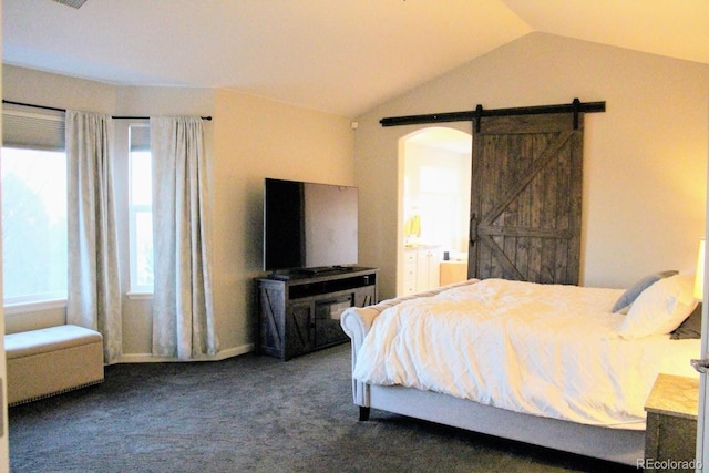 bedroom with a barn door, lofted ceiling, and carpet floors