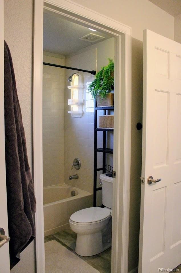 full bathroom with toilet and shower / bathtub combination