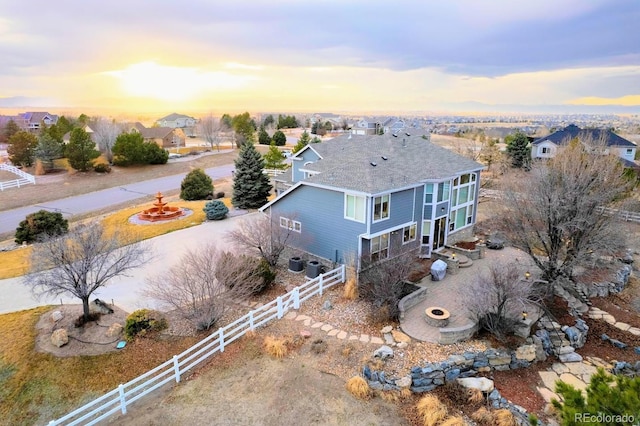 aerial view at dusk featuring a residential view