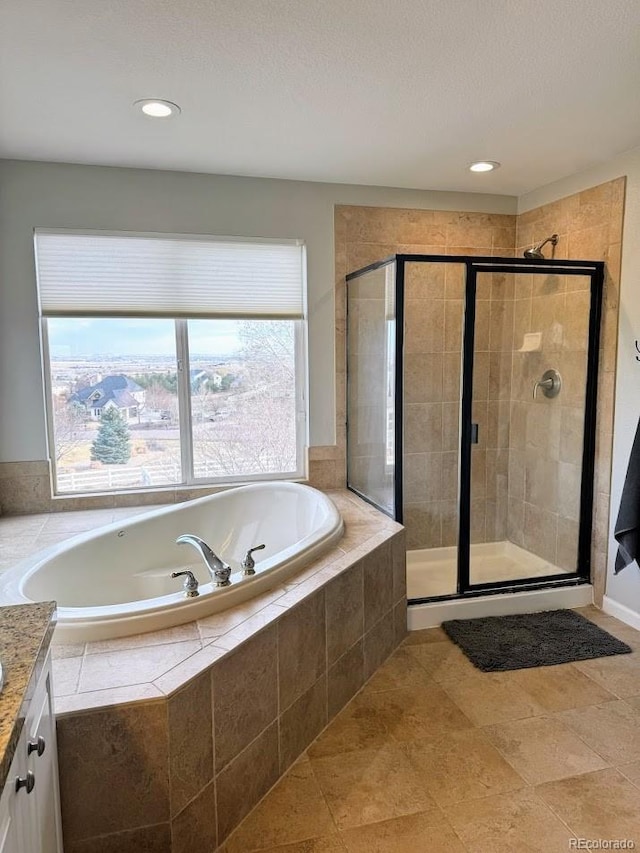 bathroom with a bath, a stall shower, and vanity