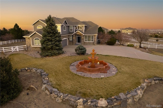 9407 E 147th Pl, Brighton, CO 80602 - view of front facade featuring a garage, curved driveway, and stone siding