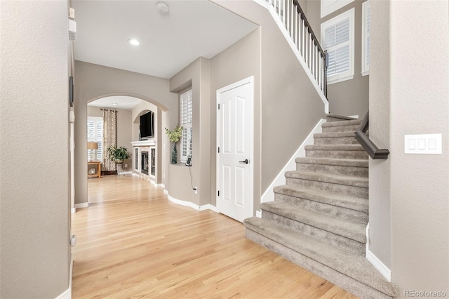 6690 S Fenton St, Littleton, CO 80123 - interior space featuring arched walkways, light wood-style flooring, and stairway