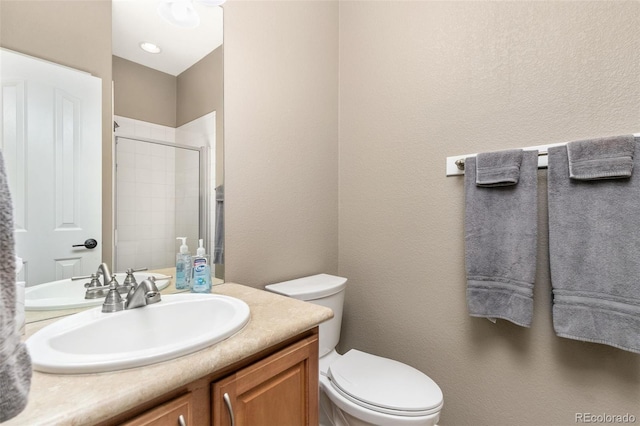 6690 S Fenton St, Littleton, CO 80123 - bathroom with vanity, a textured wall, toilet, and tiled shower