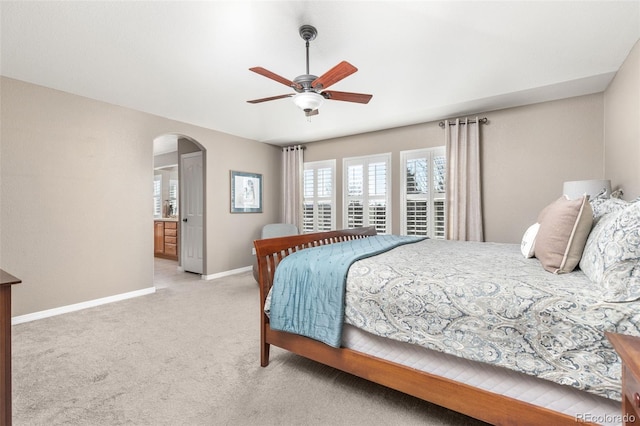 6690 S Fenton St, Littleton, CO 80123 - bedroom featuring connected bathroom, light carpet, arched walkways, a ceiling fan, and baseboards