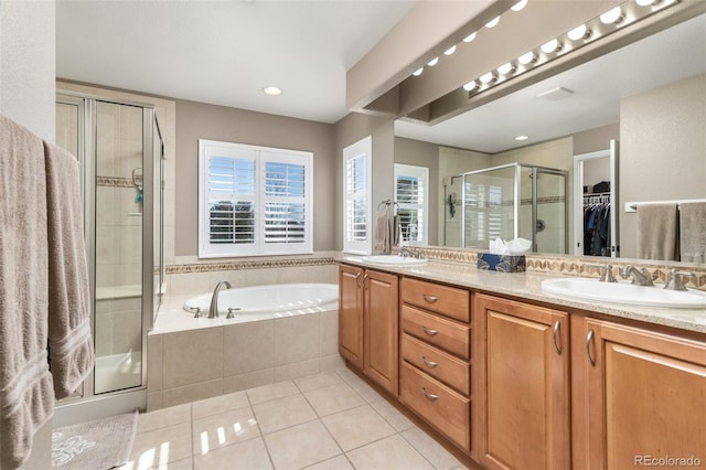 6690 S Fenton St, Littleton, CO 80123 - full bathroom featuring tile patterned flooring, a garden tub, double vanity, a sink, and a stall shower