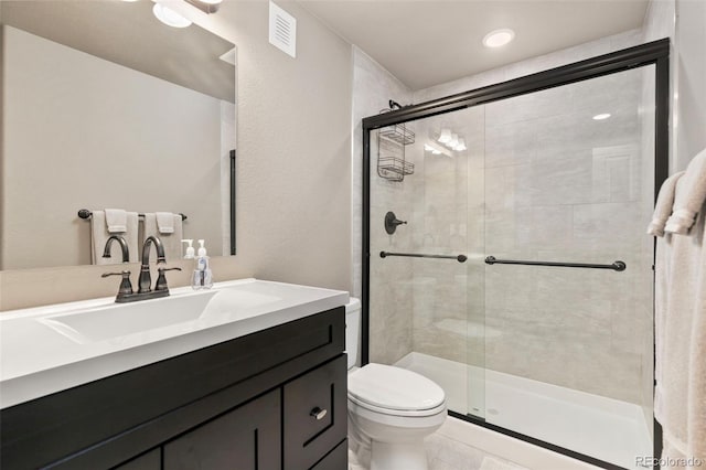 6690 S Fenton St, Littleton, CO 80123 - bathroom with visible vents, a stall shower, toilet, and vanity