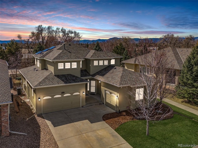 6690 S Fenton St, Littleton, CO 80123 - traditional-style home with driveway, roof with shingles, a garage, roof mounted solar panels, and stucco siding