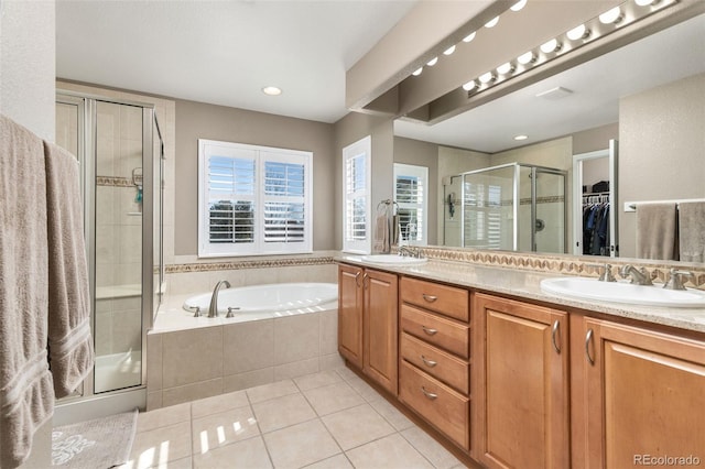 6690 S Fenton St, Littleton, CO 80123 - full bathroom featuring tile patterned floors, a shower stall, double vanity, a bath, and a spacious closet