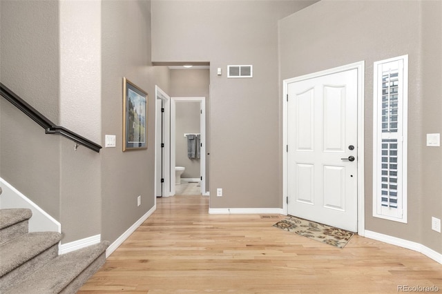 6690 S Fenton St, Littleton, CO 80123 - entrance foyer featuring light wood-style flooring, stairway, baseboards, and a high ceiling
