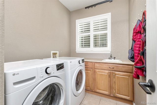 6690 S Fenton St, Littleton, CO 80123 - laundry room with washer and clothes dryer, light tile patterned floors, and cabinet space