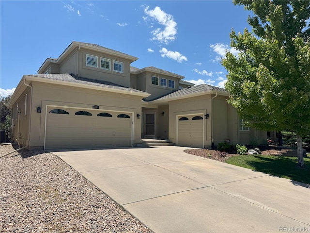 6690 S Fenton St, Littleton, CO 80123 - view of front of home with stucco siding, driveway, a garage, and cooling unit