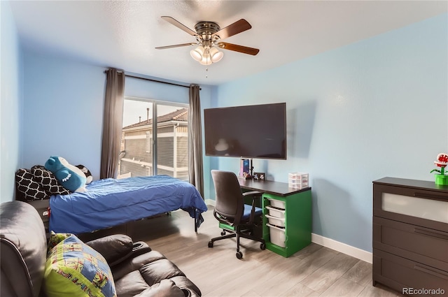 bedroom with light hardwood / wood-style floors and ceiling fan