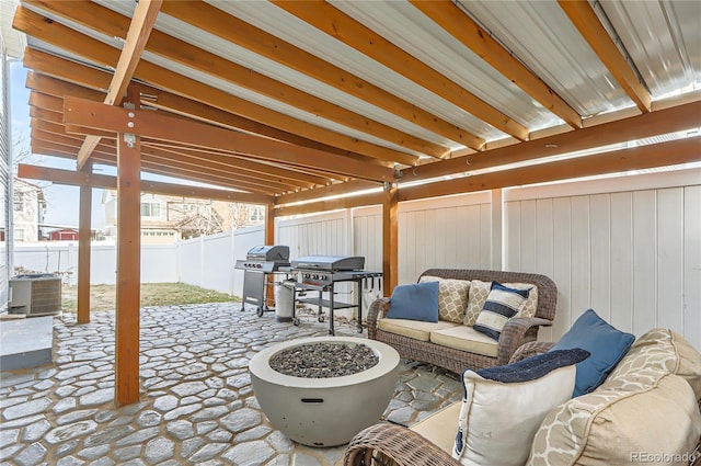 view of patio / terrace featuring central AC, grilling area, and an outdoor living space with a fire pit