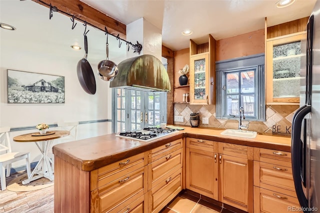 kitchen with decorative backsplash, stainless steel appliances, a healthy amount of sunlight, and sink